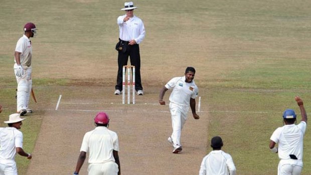 Sri Lankan bowler Rangana Herath celebrates after dismissing West Indies spinner Sulieman Benn.