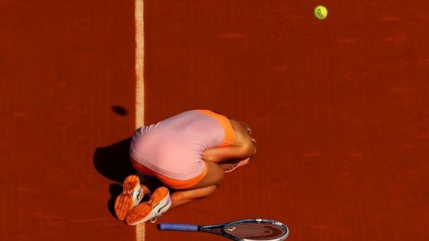 The moment of victory: Sharapova slumps to her knees after a three-hour epic against Simona Halep.