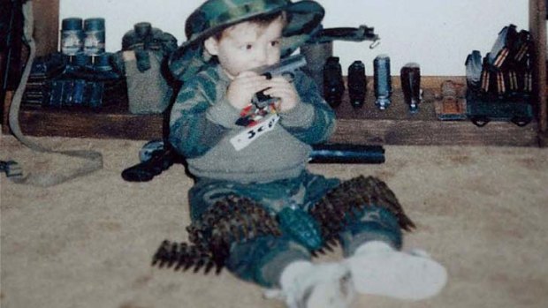 A photo found in the Lanza household shows a young boy playing with guns.