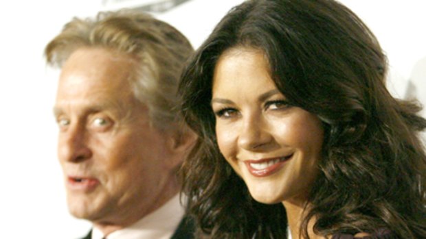 Flashing the fans ... Catherine Zeta-Jones and husband Michael Douglas.