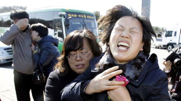 Cover-up charge … relatives cry out at the naval base at Pyeongtaek.