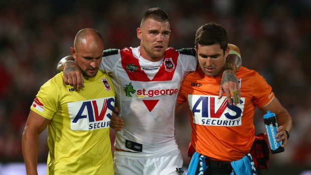 Injury scare: Dragons fullback Josh Dugan is helped from the field with an apparent ankle complaint.