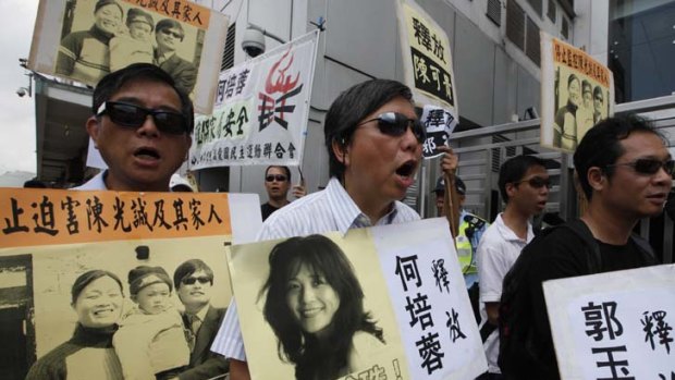 Growing fears ... pro-democracy protesters hold placards supporting Chen Guangcheng and demanding the freedom of activist He Peirong.