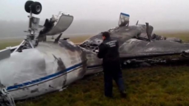 An investigator looks at the wreckage of Christophe de Margerie's Dassault Falcon jet at Moscow's Vnukovo airport.