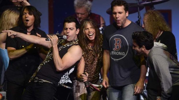 Performers, including Jordan Knight of New Kids on the Block (centre left), Steven Tyler of Aerosmith (centre) and comedian Dane Cook (centre right), perform during the Boston Marathon bombings benefit concert.