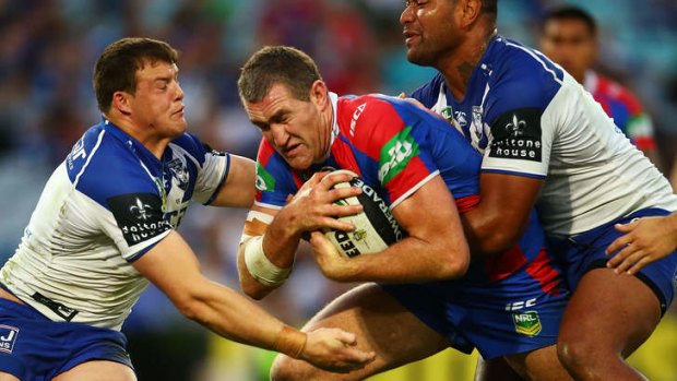 Sin-bin decision 'harsh': Chris Houston is tackled during the Knights' elimination final win over the Bulldogs.