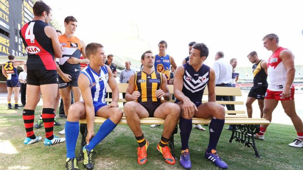 Friends for the day: (seated left to right) North Melbourne captain Andrew Swallow, Hawthorn captain Luke Hodge and Fremantle captain Matthew Pavlich.