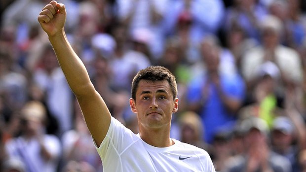Bernard Tomic celebrates his win over France's Richard Gasquet in their third round men's singles match on day six at Wimbledon.