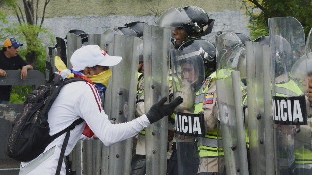 A protester yells at police during an opposition march in Caracas on May 11.
