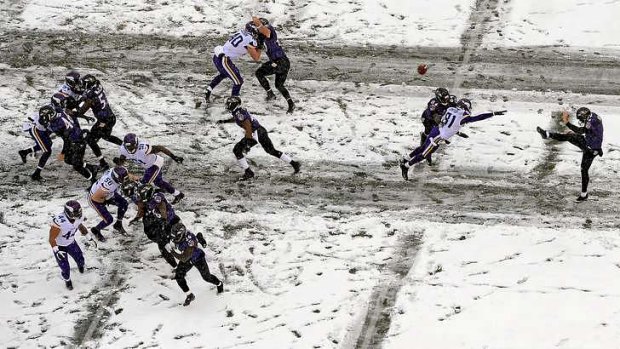 Punter Sam Koch of the Baltimore Ravens kicks the ball away to the Minnesota Vikings.