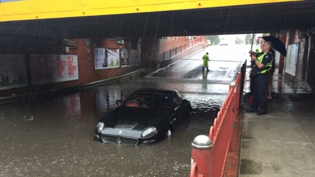 A Maserati stricken in floodwater on Victoria Street, Seddon during storms in Melbourne on December 2, 2017.
