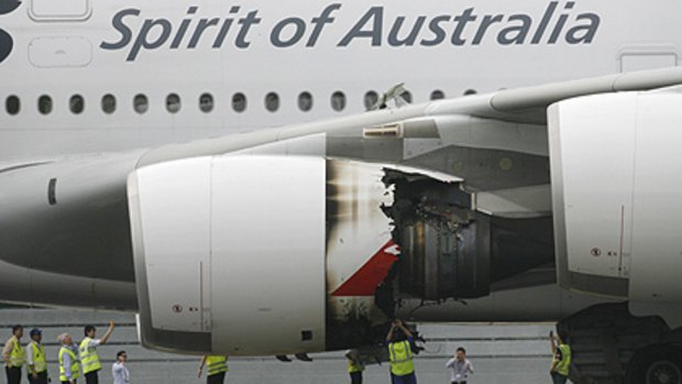 Technicians look at the damaged engine of QF32 after it was forced to make an emergency landing in Singapore on November 4.