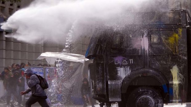 Protesters are targeted by police water cannon during  demonstrations.