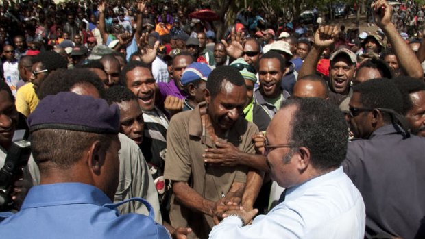 Peter O'Neill greets supporters in Port Moresby.