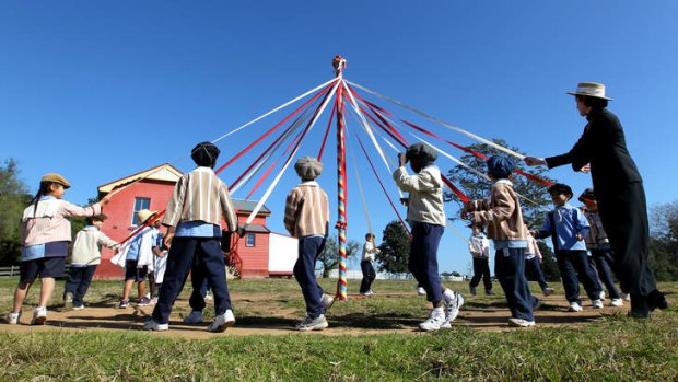Spring in their step: Pupils from St Patrick's Catholic School dance around the maypole at Rouse Hill House, which celebrates its 200th birthday this month.