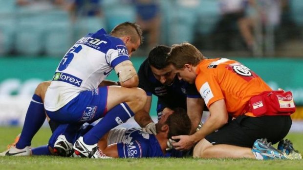 Mitch Brown is treated after being knocked out during the round one NRL match against the Broncos.