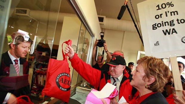 The AEU's Mary Bluett delivers protest postcards to then Premier John Brumby in 2007.