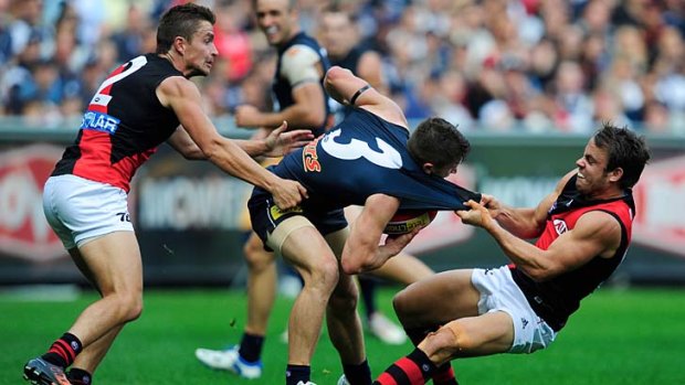 Essendon's Sam Lonergan tackles Carlton's Marc Murphy when the teams met in round four this year.