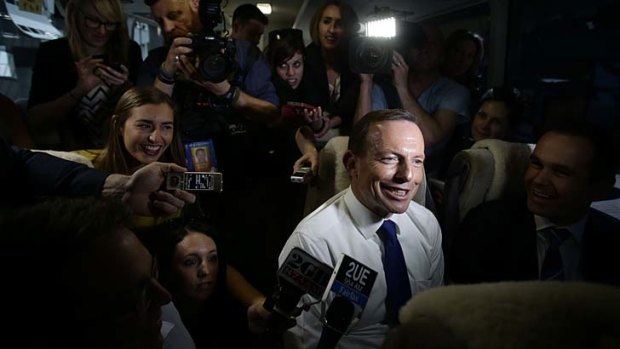Election 2013: Opposition Leader Tony Abbott speaks to media on the bus on the way to Ekka