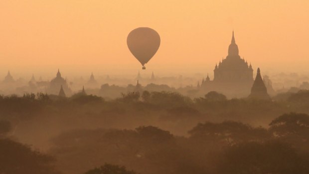 A hot air balloon floats over the temple-studded plains of Bagan, Burma's primary archaeological site.
