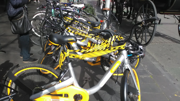 oBikes wrapped in official City of Melbourne tape declaring them illegal litter.