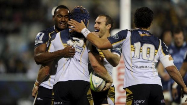 The Brumbies celebrate a try against the Blues on Friday night.
