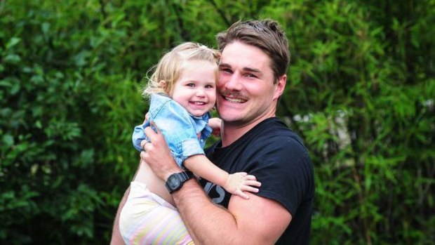 Ben Mowen with his 18-month-old daughter Eleanor at his home.