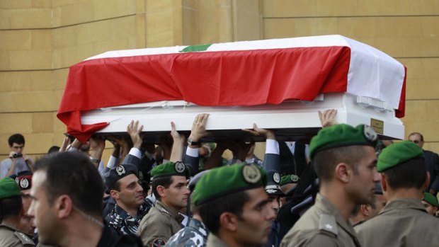 The coffins of top intelligence chief General Wissam al-Hassan and his bodyguard, arrive in downtown Beirut during their funeral procession.