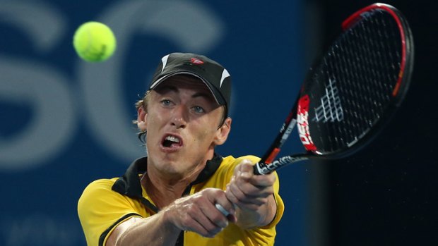 Brisbane's John Millman hits a return to Andy Murray of Great Britain during their men's singles match at the Brisbane International tennis tournament.