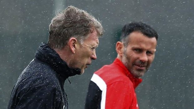 Next in line: interim Manchester United manager Ryan Giggs, right, speaks with his predecessor David Moyes.
