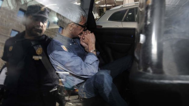Spanish train driver Francisco Jose Garzon Amo leaves the police station to be transferred to the courthouse.