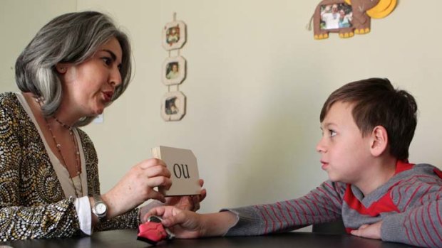Extra help ... speech pathologist Vicki Selwyn-Barnett with Peter Lukeides, 7, who has improved his literacy by participating in a special therapy program.