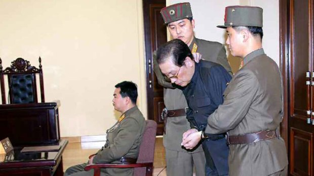 Condemned: Jang Song-thaek, who was later executed, is escorted into court on December 12 after he was branded a traitor.