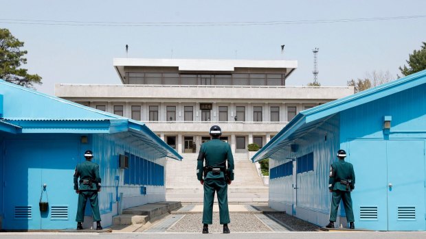 South Korean soldiers stand guard at the Military Demarcation Line in the Demilitarized Zone (DMZ) in the border village of Panmunjom, South Korea.