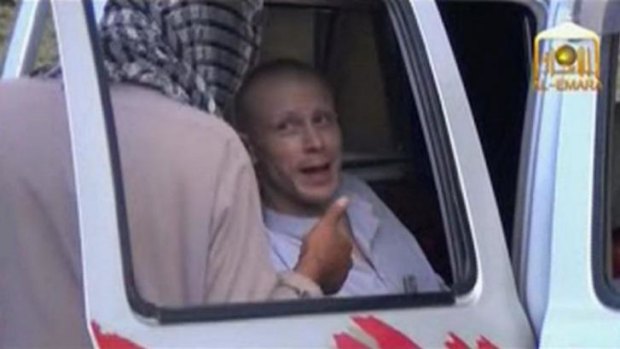 Bowe Bergdahl talks to a Taliban militant as he waits in a truck before his release.