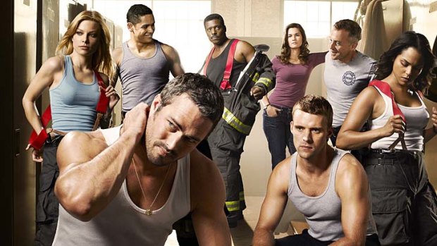 The cast of <em>Chicago Fire</em>: Taylor Kinney and Jesse Spencer in the foreground, with Lauren German, Charlie Barnett, Eamonn Walker, Teri Reeves, David Eigenberg and Monica Raymund.