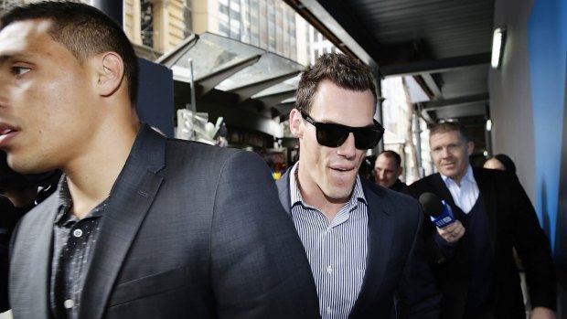 Tight-lipped: John Morris, centre, and Anthony Tupou try to avoid the waiting media after meeting with lawyers.