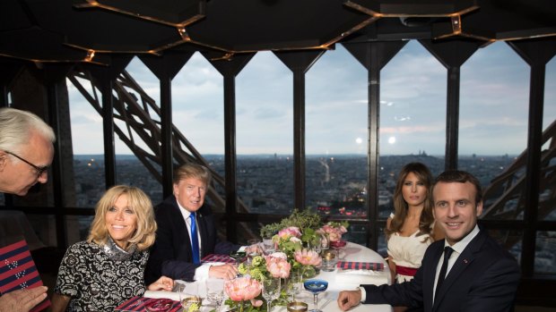Donald Trump, US first lady Melania Trump, French President Emmanuel Macron his wife Brigitte Macron, sit for dinner at the Jules Verne Restaurant in the Eiffel Tower on Thursday.