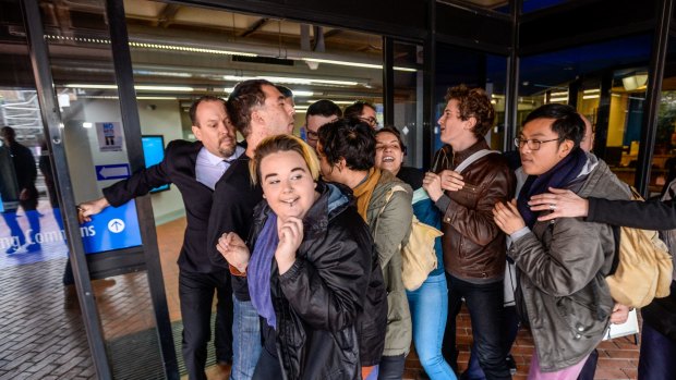 The Age, News, picture by JustinMcManus 28/08/2015. Education Minister Christopher Pyne visits Victoria Uni Nicholson Campus in Footscray. Protesters try to enter the Telford building where Pyne was speaking.
