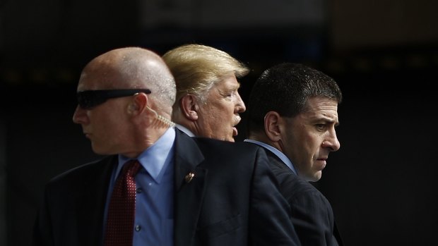 Secret Service Agents surround Donald Trump in response to an incident during a campaign event in Dayton, Ohio.