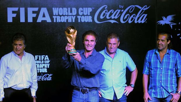Former Argentine star Oscar Ruggeri (second left) holds up the FIFA World Cup. With him are former players Ubaldo Matildo Fillol (left), Julio Olarticoechea (second right) and Sergio Batista (right) in Mar del Plata, Argentina. The Cup, which is on being taken on tour, will remain in Mar del Plata until Wednesday.