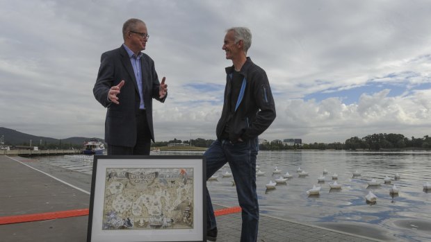 Gang Gang. The Canberra Times cartoonist, David Pope, right, today presented a copy of his Lake Burley Griffin artwork to National Capital Authority CEO, Malcolm Snow, on the shores of the lake. March 3rd. 2015 The Canberra Times photograph by Graham Tidy.