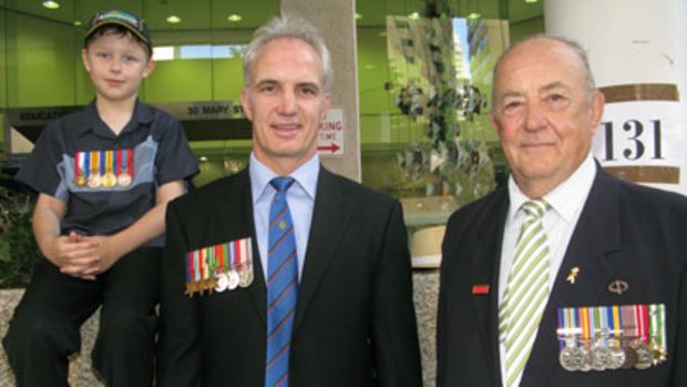 Eight-year-old Griffin Ducie (from left) proudly displaying the medals his great-grandfather won fighting at Gallipoli as a teenager; Griffin's father Greg Ducie wearing with his uncle's medals, won on the battlefields of Crete during WWII and  Ron Ducie, vietnam veteran wearing his own medals.