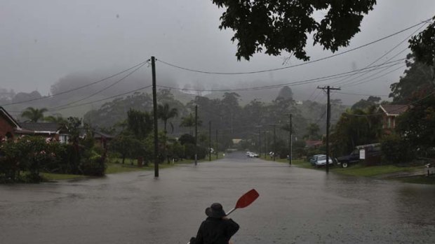 No place for a stroll &#8230; a resident resorts to kayaking in a Coffs Harbour street after nearby creeks spilled over. The rain is expected to continue today.