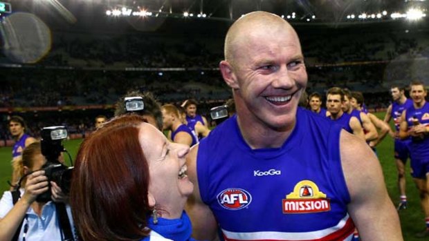 All smiles: Julia Gillard celebrates with Western Bulldogs full-forward Barry Hall after the club's sensational win yesterday.