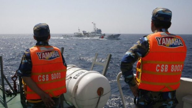 Vietnamese marine guards monitor a Chinese coast guard vessel in disputed waters in May.