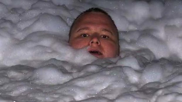 Time for bath .... Kim Dotcom soaks in a tub full of suds.