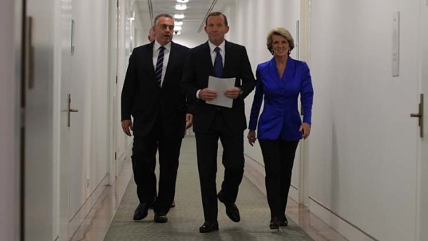 The frontrunner: Tony Abbott, flanked by Joe Hockey and Julie Bishop, sets out to deliver his budget reply on Thursday.