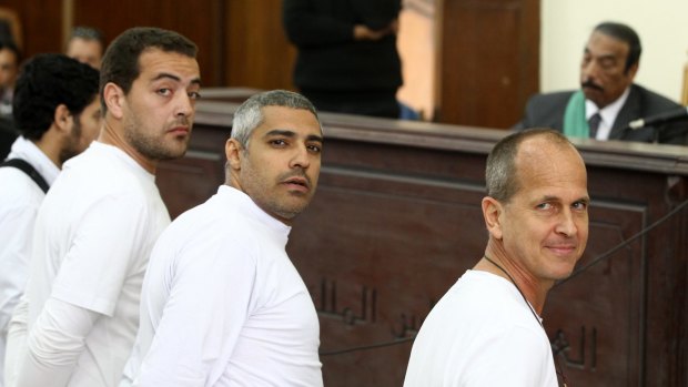 Al Jazeera producer Baher Mohamed, left, Canadian-Egyptian bureau chief Mohamed Fahmy, centre, and Peter Greste, right, stand in front of the judge's bench during their trial in March, 2014.