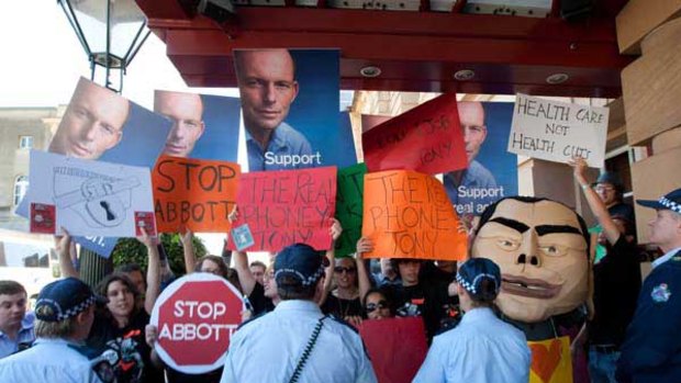 Protesters and supporters wait for Federal Opposition Leader Tony Abbott to arrive at a press conference at the Conrad Treasury Hotel in Brisbane. <i>Picture: AAP/Paul Harris</i>